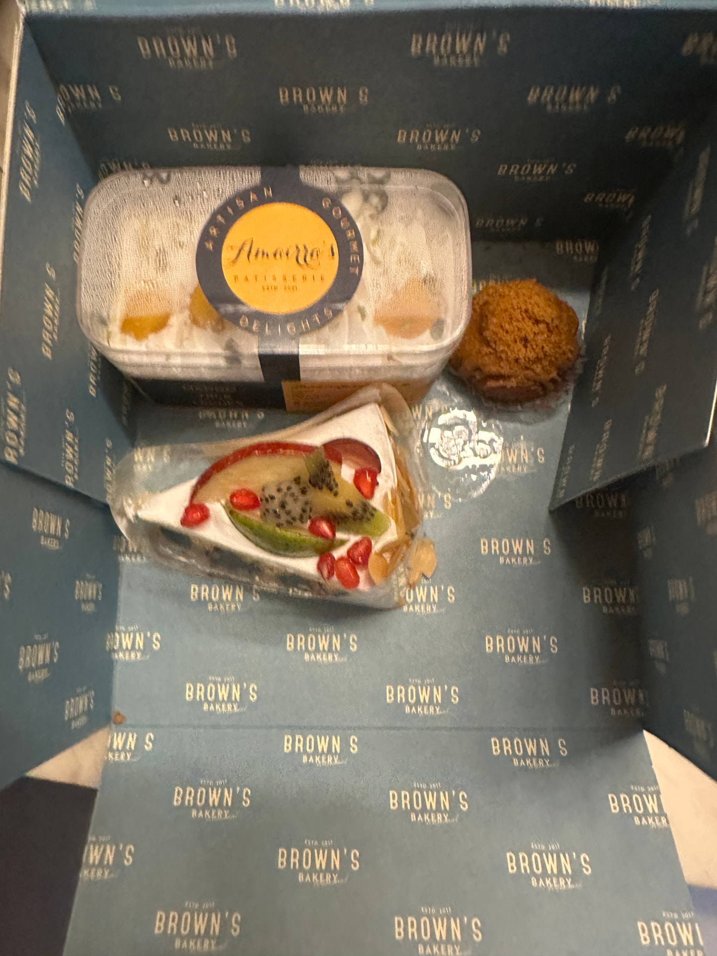 Amairra's custard tub, fresh fruit cake slice and a muffin in a Brown's Bakery box