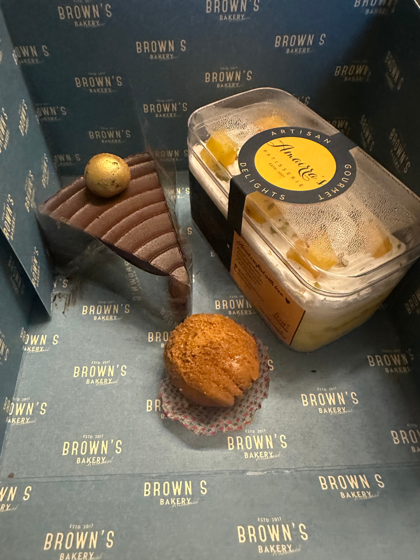 Chocolate mousse slice, caramel muffin and an Amairra's mango custard tub